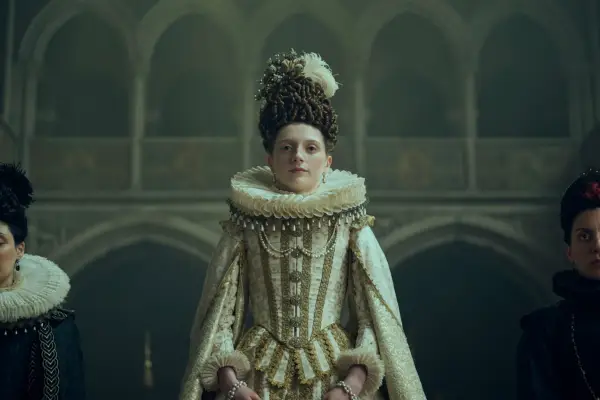 Aine McNamara in a renaissance-style white dress and ruff as The Spanish Infanta in Mary and George.