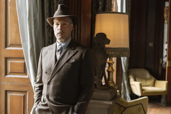 John Light as Hercule Flambeau in Father Brown in a brown suit