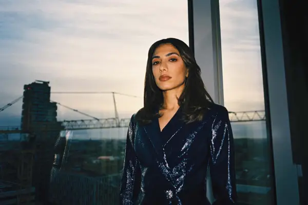 Evin Ahmad stars in Snabba Cash wearing a glittery blazer, looking into camera