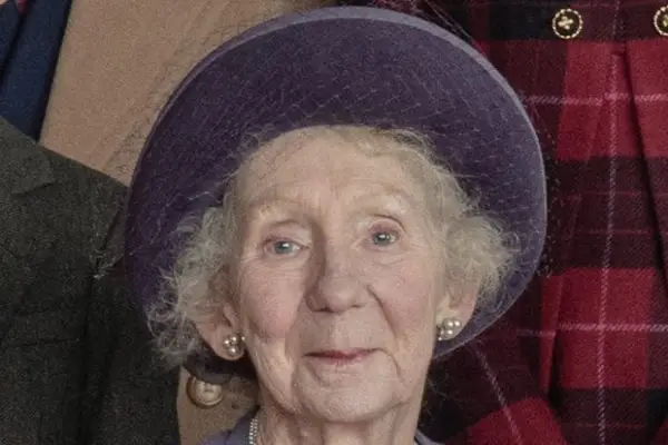 Marcia Warren as Queen Elizabeth The Queen Mother in The Crown season 5 wearing a purple hat