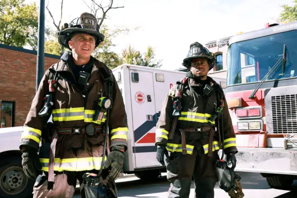 Christopher Herrmann and Darren Ritter wearing their firefighters uniforms, stood outside