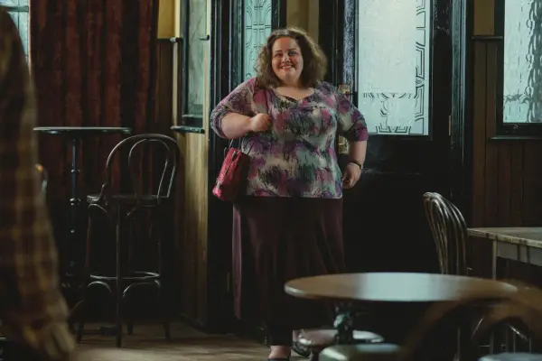 Jessica Gunning as Martha walking into a pub and standing in the entrance smiling at the bar in Baby Reindeer.