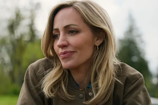 Zibby Allen as Brie. She is smiling.