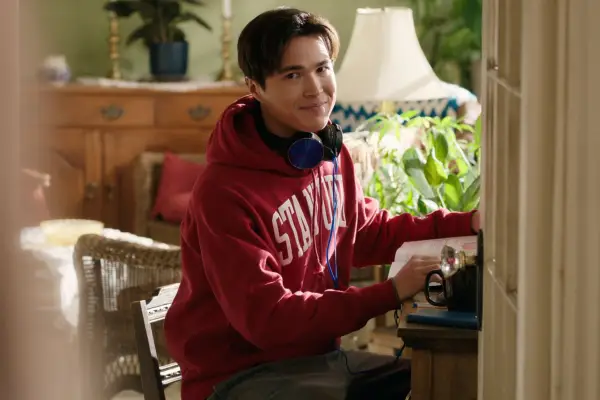 Kai Bradbury as Denny in Virgin River. He is wearing a red hoodie and is smiling.