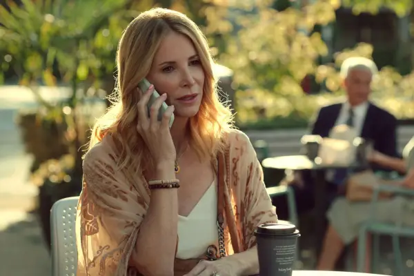 Jenny Cooper as Joey Barnes. She is holding a phone to her ear whilst looking concerned.