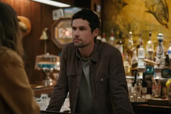 Ben Hollingsworth as Dan Brady in Virgin River standing behind a bar