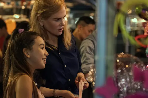 Nicole Kidman as Margaret, stood alongside another woman and looking at something off screen in Expats