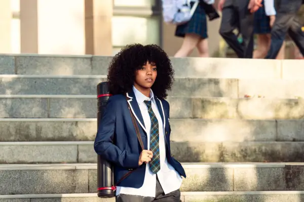 Regan Aliyah as Juliana Porter, wearing her school uniform, walking down some steps