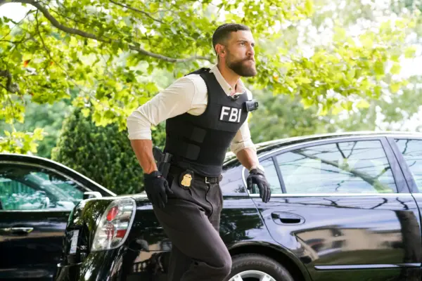 An FBI agent runs into an active situation, wearing a bulletproof vest