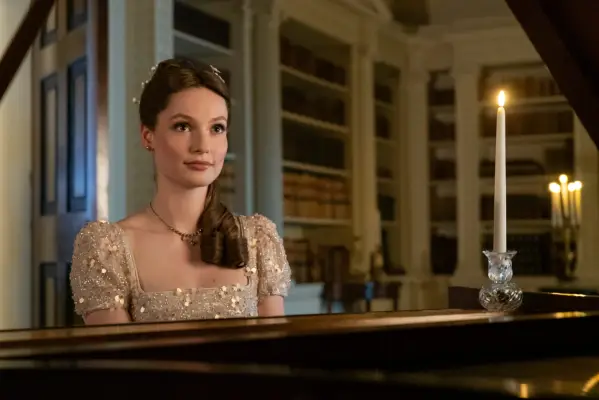 Hannah Dodd as Francesca Bridgerton, sitting at the piano