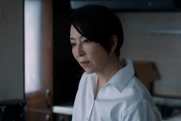 Nagata wearing a white shirt in an indoor setting