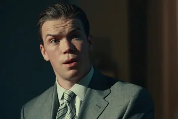 Will Poulter in Dopesick in a grey suit looking surprised