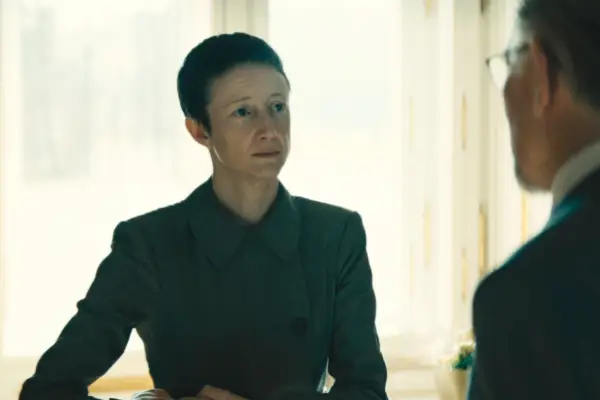 Andrea Riseborough as The Palace Manager in The Regime, with a cropped haircut and wearing a shirt
