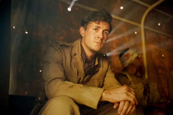 Jonah Hauer-King as Harry Chase in World on Fire season 2, sitting and looking concerned