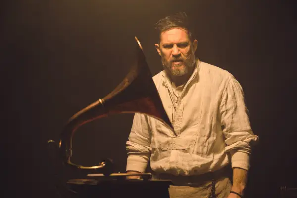 Tom Hardy as Alfie Solomons in Peaky Blinders behind a music box