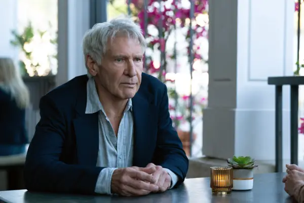 Harrison Ford in Shrinking, sat at a table