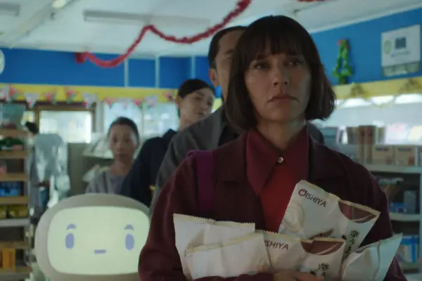 Suzie (Rashida Jones) stands in line at a supermarket holding several pouches of noodles