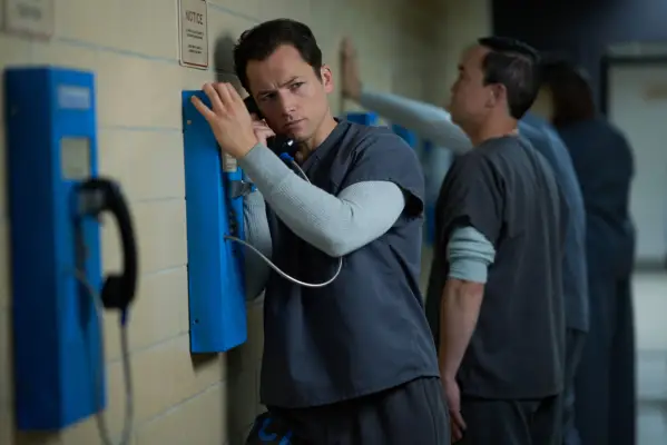 Taron Egerton as Jimmy Keene in Black Bird using a phone in prison