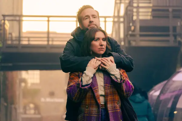Rafe Spall with his arms round Esther Smith in Trying looking in the distance
