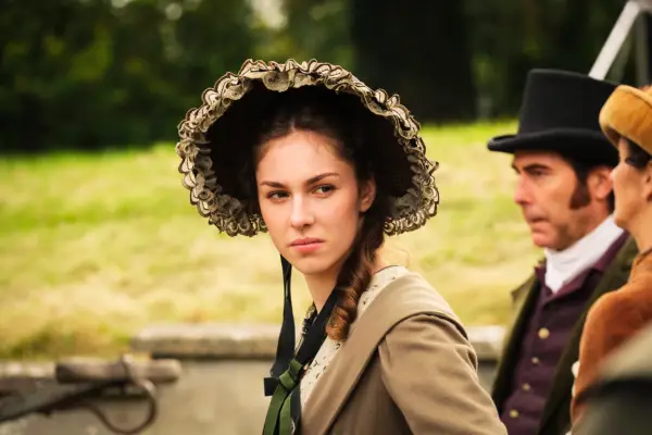 Augusta Markham at in a carriage wearing a dress and bonnet