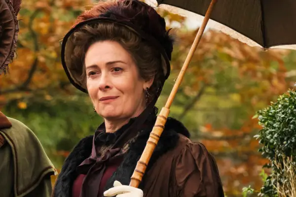 Lady Montrose stood outside in a dress and bonnet, holding a parasol