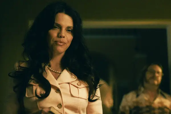 Carmen, wearing a white shirt, smiling