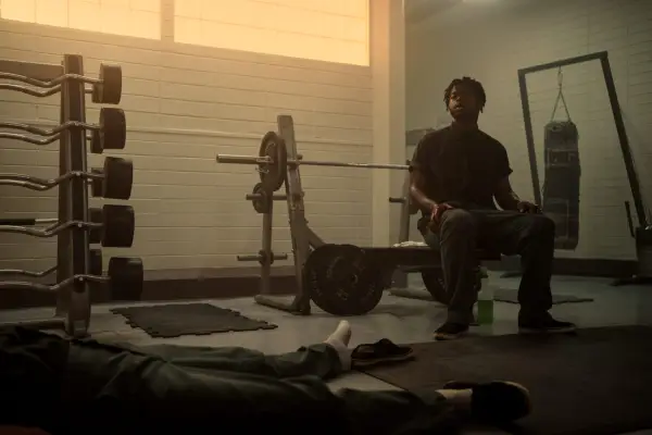 Furly Mac as Christopher Scarver sat overlooking a dead body in a prison gym.