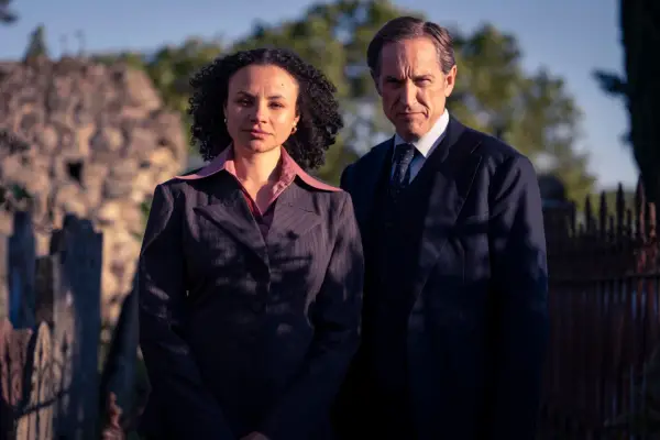 Bertie Carvel and Carlyss Peer in Dalgliesh, looking at the camera