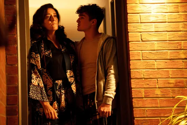Maria Doyle Kennedy as Birdy, standing in her doorway next to her nephew