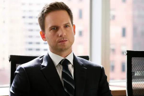 Patrick J. Adams as Mike Ross in Suits sat in an office