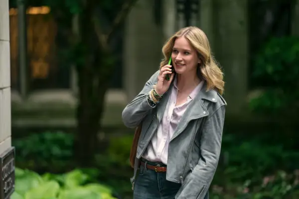 Elizabeth Lail walks along as Guinevere Beck on the phone in a scene from You season 5.