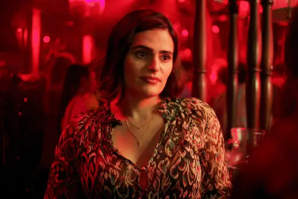 Martha standing in a pub by the door