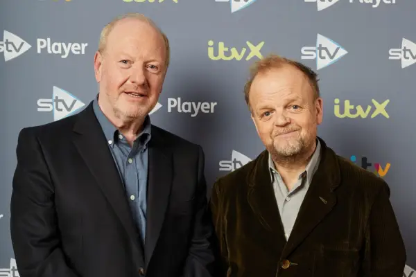 Alan Bates and Toby Jones stood together on a red capet