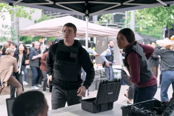 Gabriel Basso as Peter Sutherland and Amanda Warren as Catherine in The Night Agent standing under a gazebo