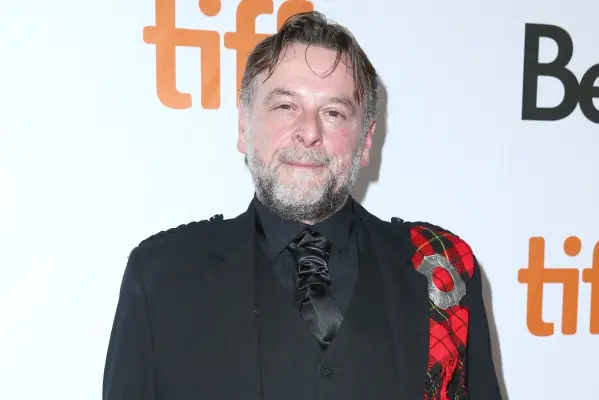 Gilly Gilchrist in a black suit and kilt