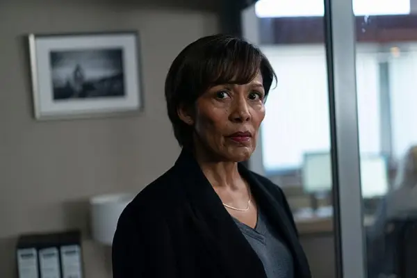 Caroline Lee-Johnson in Rebus in a black jacket and grey top