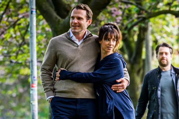 Lockie and Rhona walking together with their arms wrapped around one another