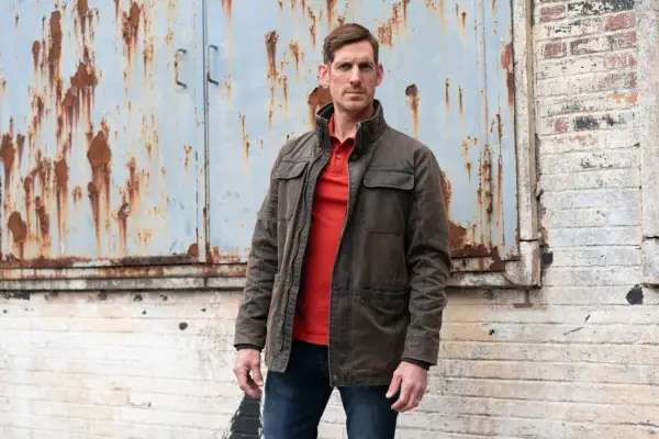 Neil Mackenzie standing in an industrial estate, facing the camera