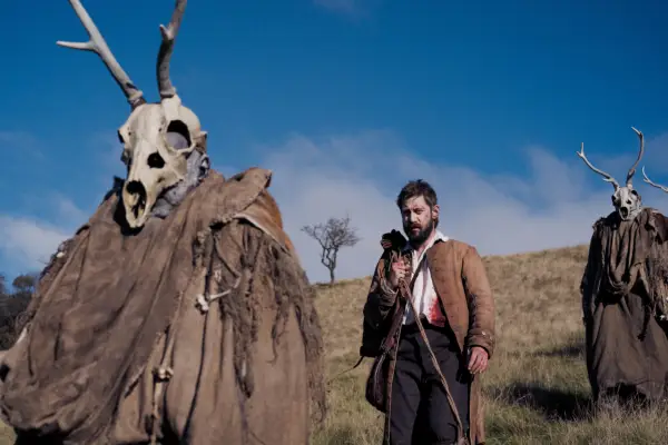Michael Socha as David Hartley with the Stag Men in The Gallows Pole.