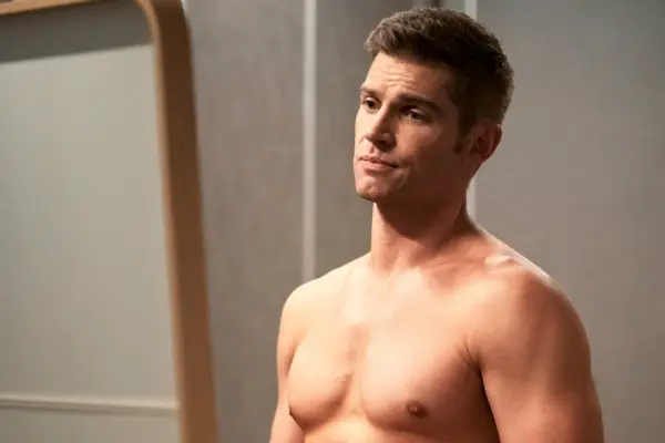 Cooper stood in his bedroom with his shirt off, looking forlorn