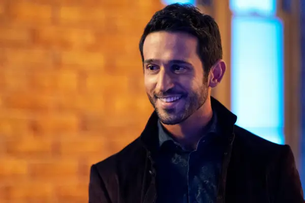 Majid with a smile on his face while standing outside a bar