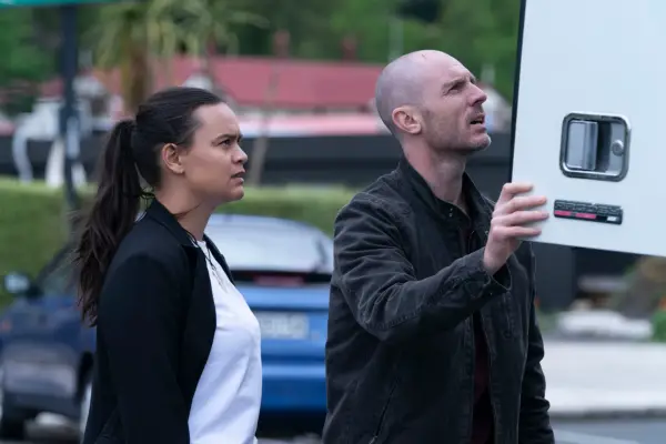 Diana (Acushla-Tara Kupe) and Theo (Richard Flood) in The Gone, looking into the back of a van with confused faces.