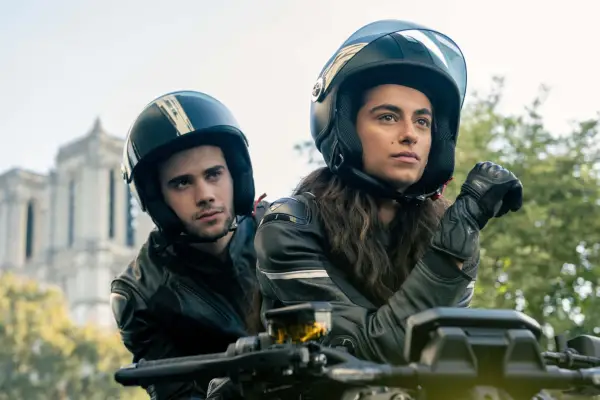 Roi and Cameron in riding a motorcycle in Money Heist: Berlin