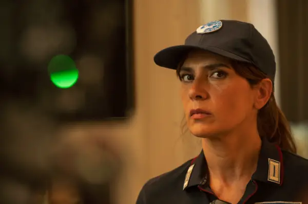 Maya Sansa in The Iris Affair, wearing a police uniform and cap.