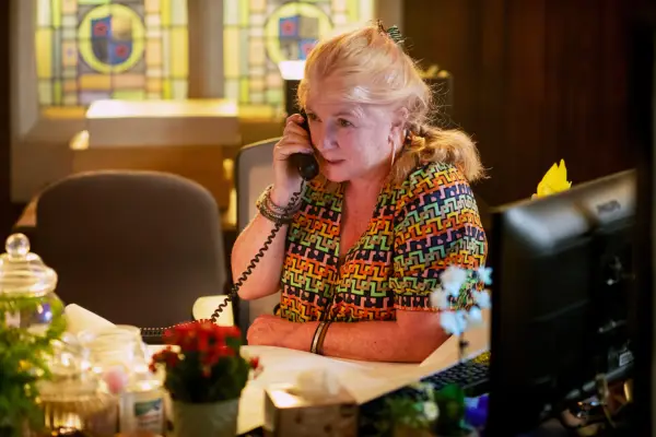 Margo sat at her desk at the police station on the phone