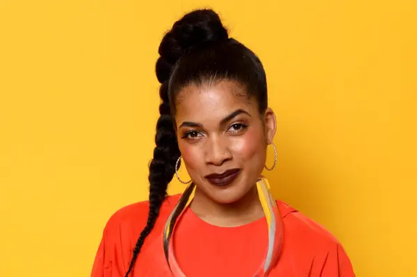 Rebekah Murrell in a red shirt against a yellow background