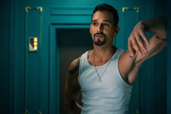 Bruce leans against a doorway in Money Heist: Berlin