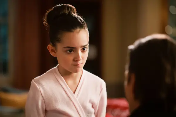 Ella Grace Helton as Katie wearing a pink ballet outfit with her hair in a bun