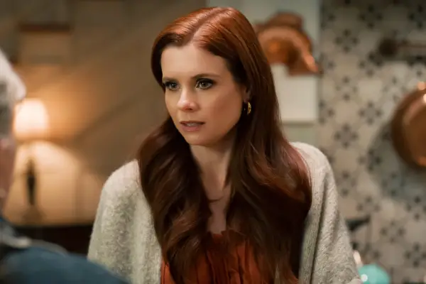 Close-up of JoAnna Garcia Swisher as Maddie, wearing a white cardigan, looking worried