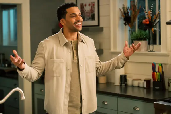 Leland B. Martin as Alexander standing in a kitchen with his arms outstretched